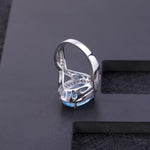 Anillo de Topacio azul cielo ovalado rodeado de Zirconia cúbica - Cherine Jewelry